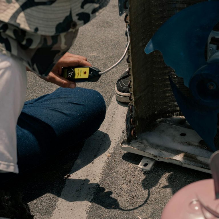 A Person with a Hat Sitting on the Floor Holding a Unit Switch